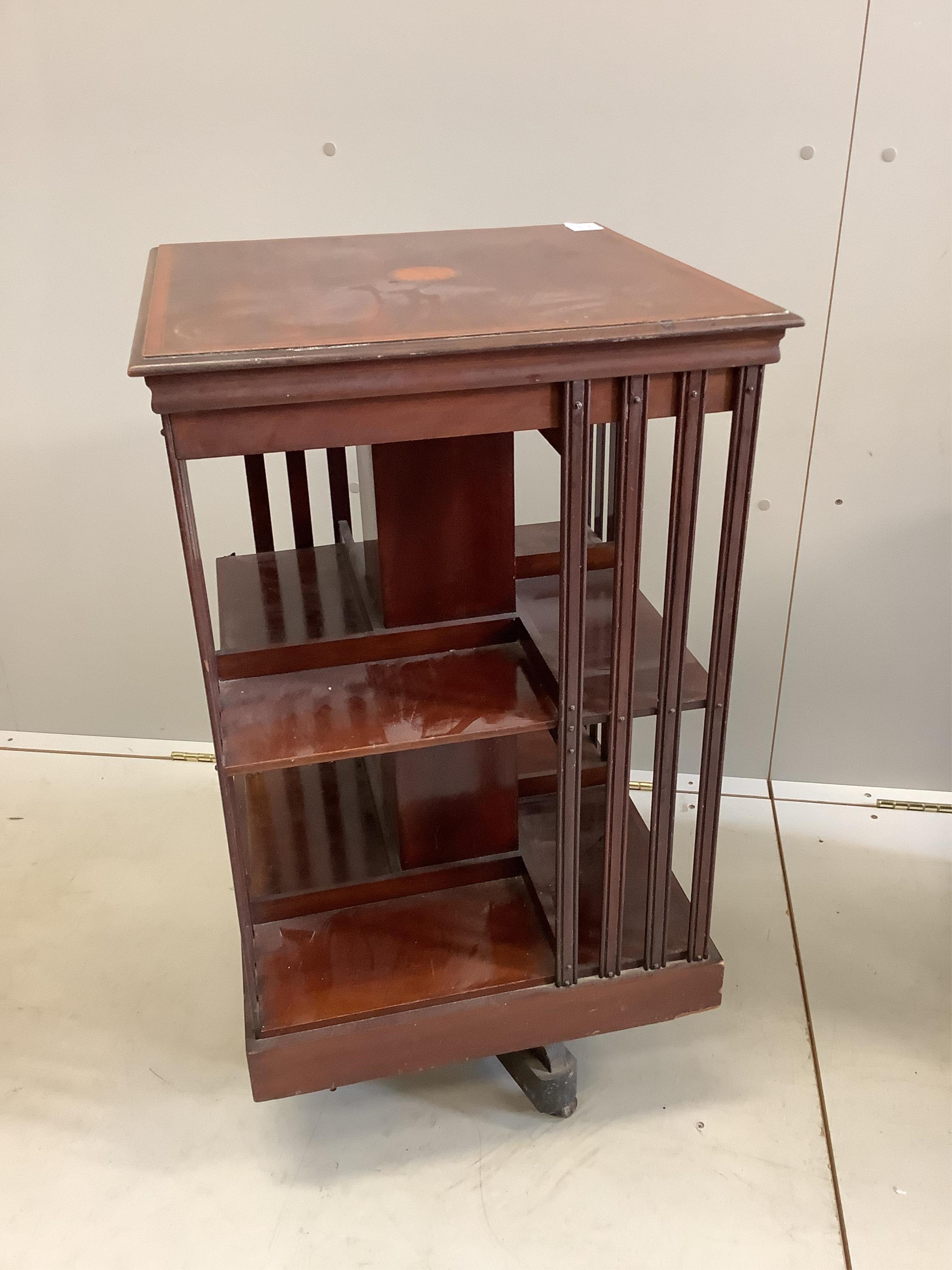 An Edwardian inlaid mahogany revolving bookcase, width 47cm, depth 47cm, height 84cm. Condition - poor